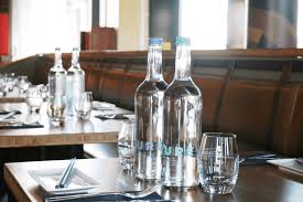 Photo 1 of glass water bottle on restaurant table